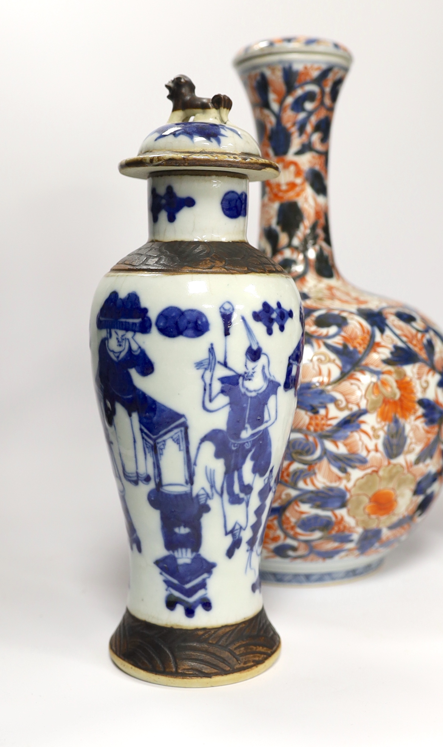 A pair of Chinese blue and white crackleware vases and covers and an Imari vase and cover, largest 31cm high